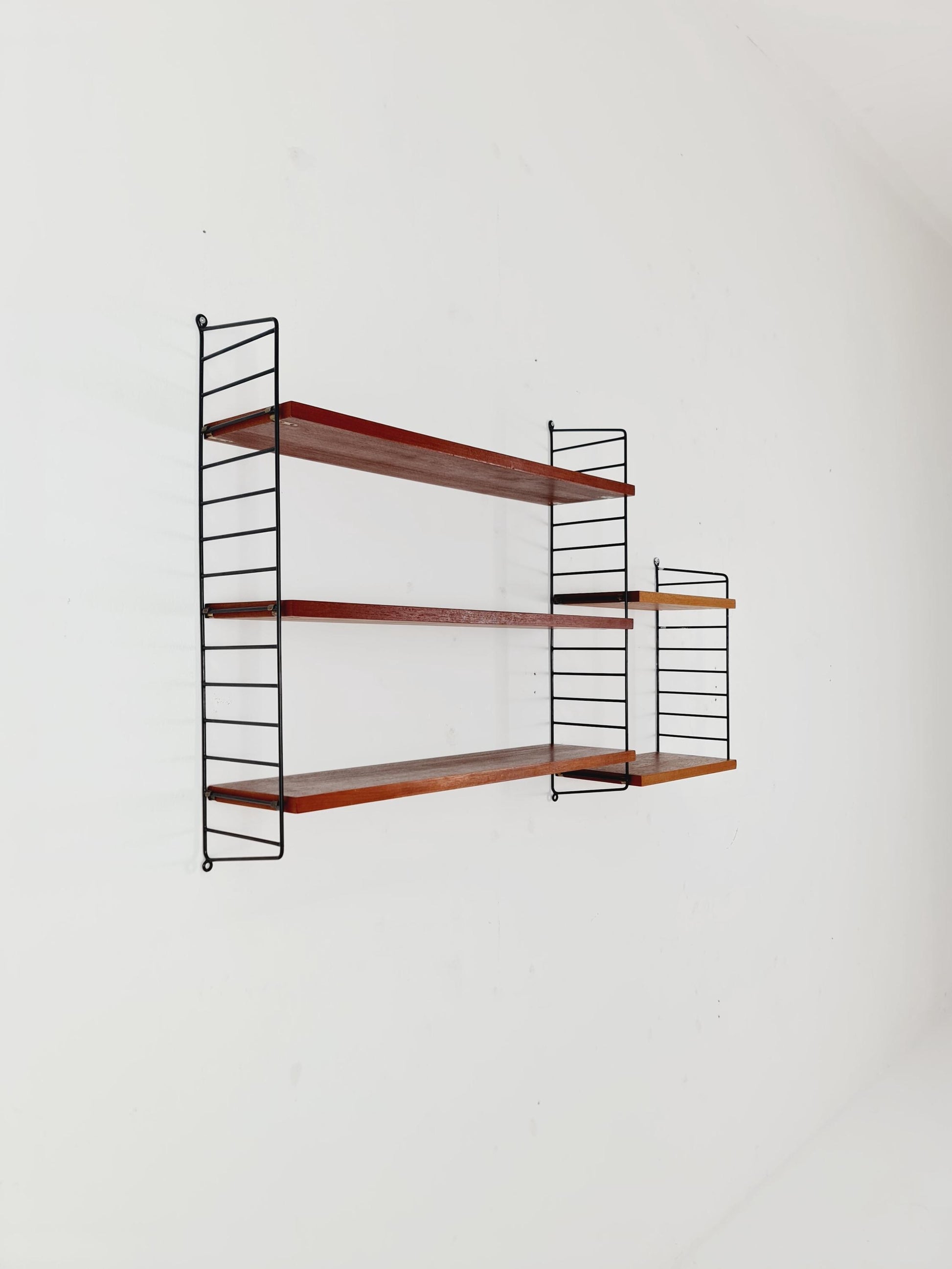 Original MCM Teak shelving system - consists of black lacquered metal ladders, from string Stockholm 1960s
