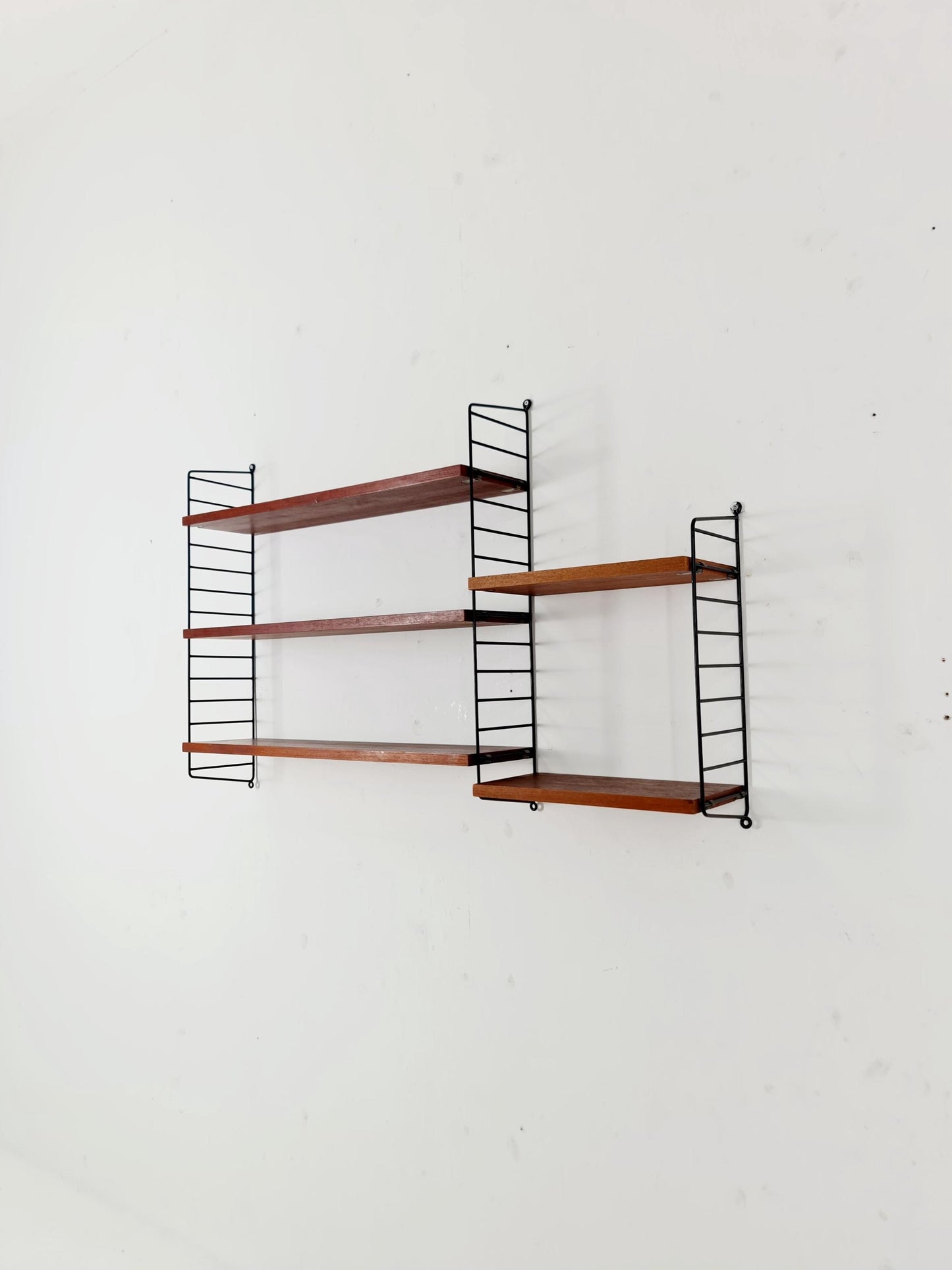 Original MCM Teak shelving system - consists of black lacquered metal ladders, from string Stockholm 1960s