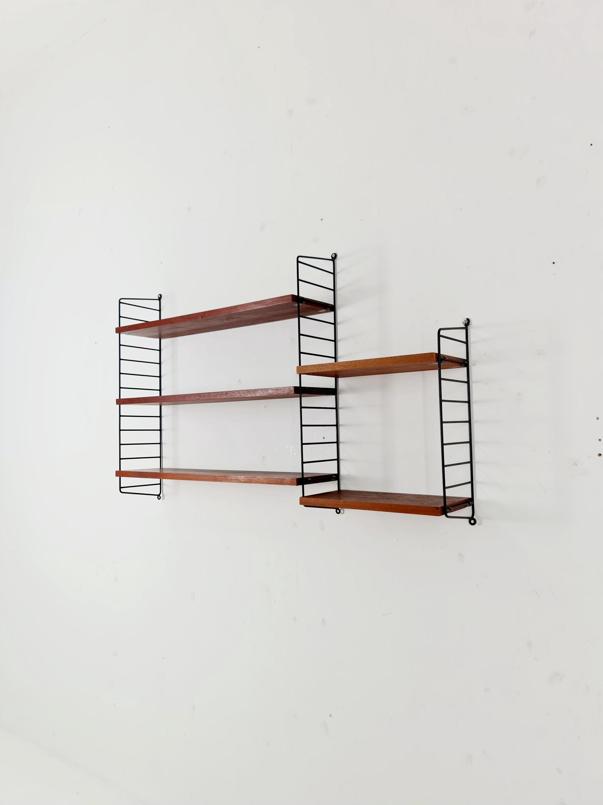 Original MCM Teak shelving system - consists of black lacquered metal ladders, from string Stockholm 1960s