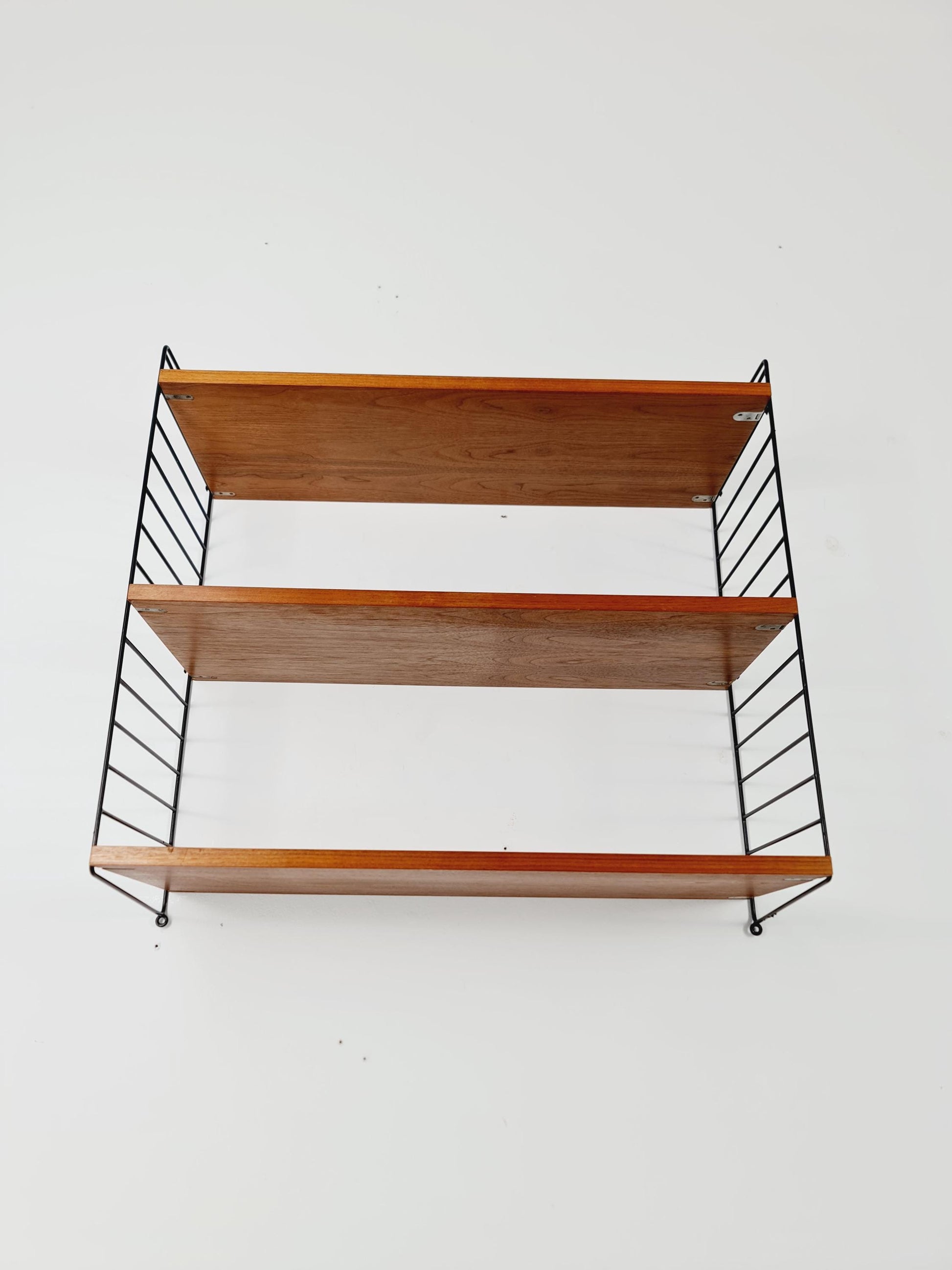 Original MCM Teak shelving system - consists of black lacquered metal ladders, from string Stockholm 1960s