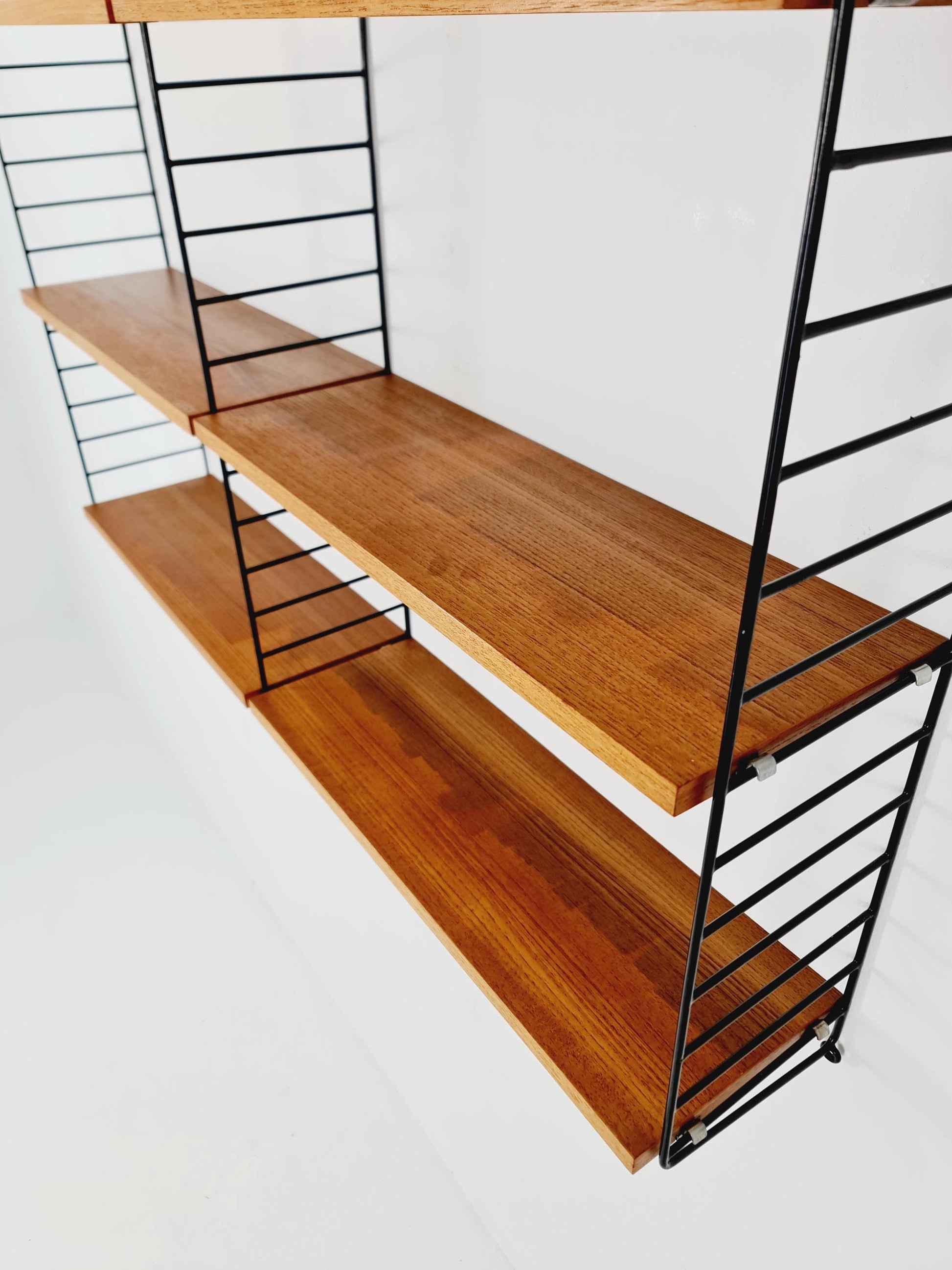 Original MCM Teak shelving system - consists of Black lacquered metal ladders, from string Stockholm 1960s