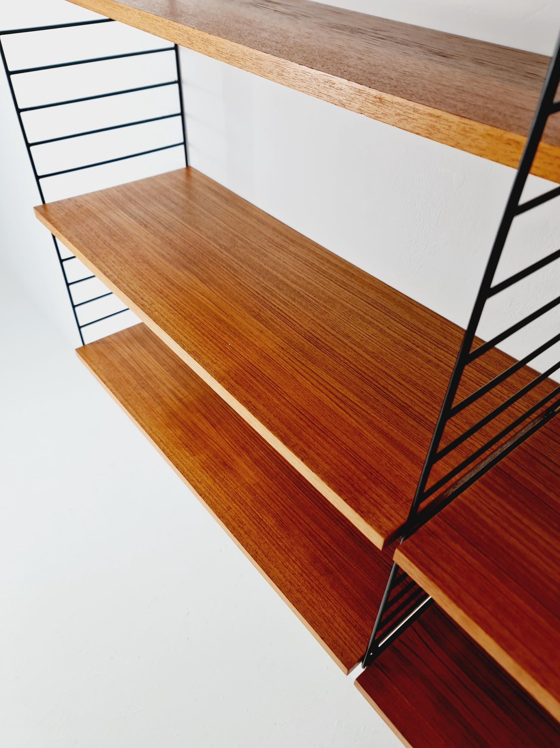 Original MCM Teak shelving system - consists of black lacquered metal ladders, from string Stockholm 1960s