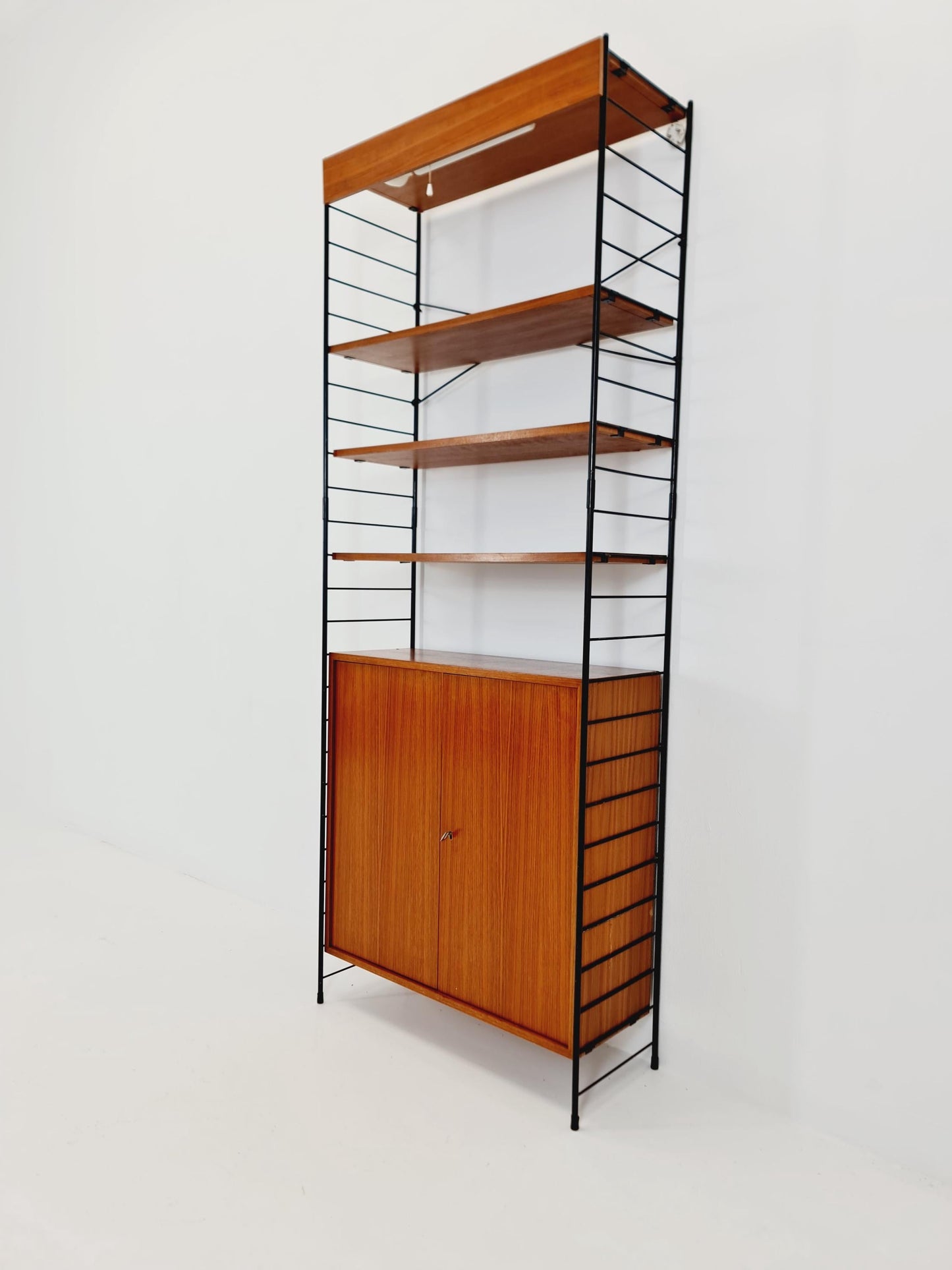 Free standing String shelf-system, bookcase with cabinet and lighting teak by WHB Germany, 1950s