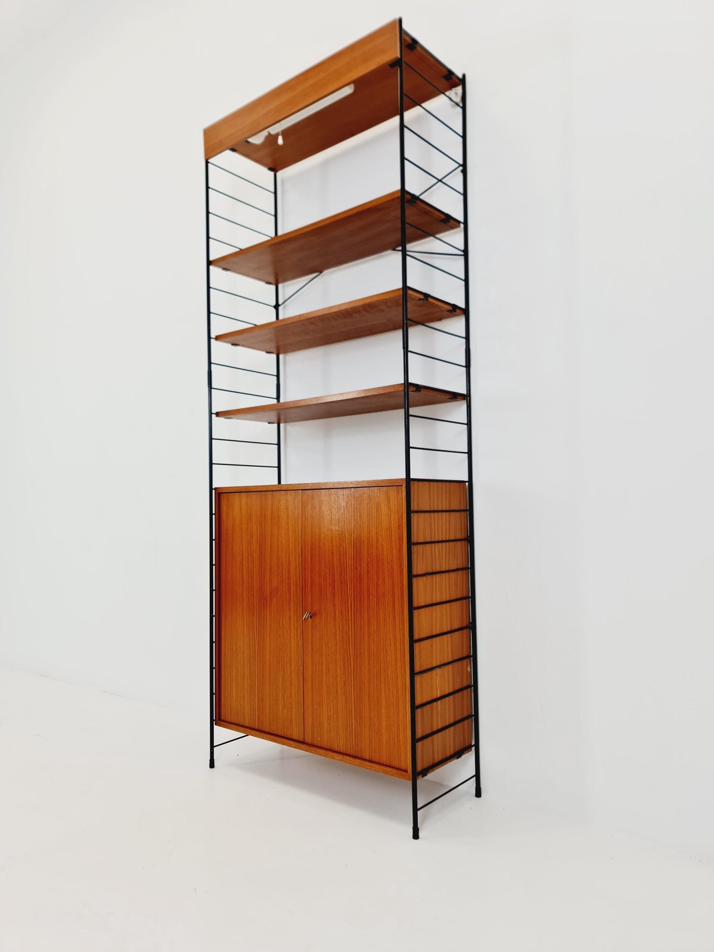 Free standing String shelf-system, bookcase with cabinet and lighting teak by WHB Germany, 1950s