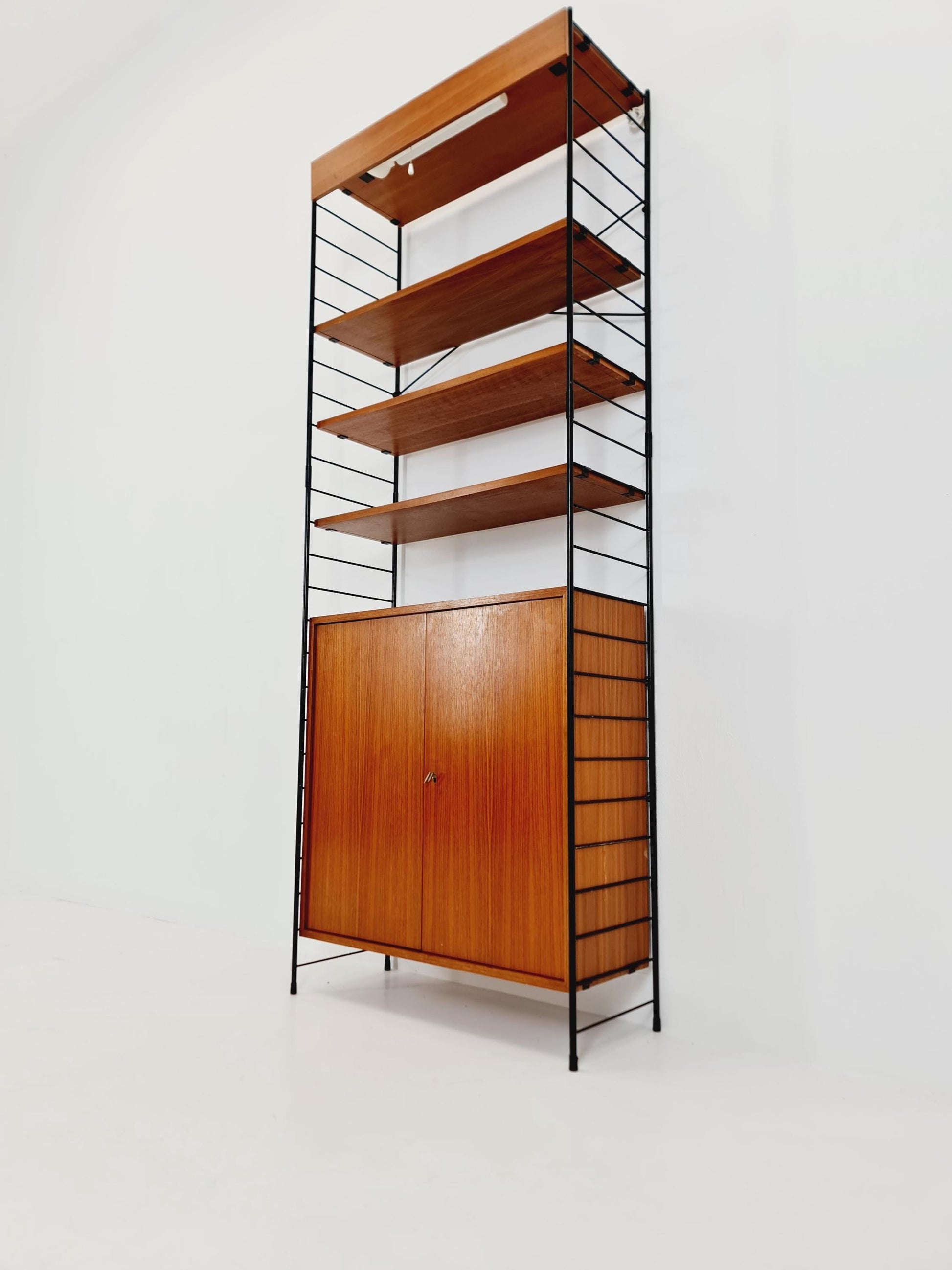 Free standing String shelf-system, bookcase with cabinet and lighting teak by WHB Germany, 1950s