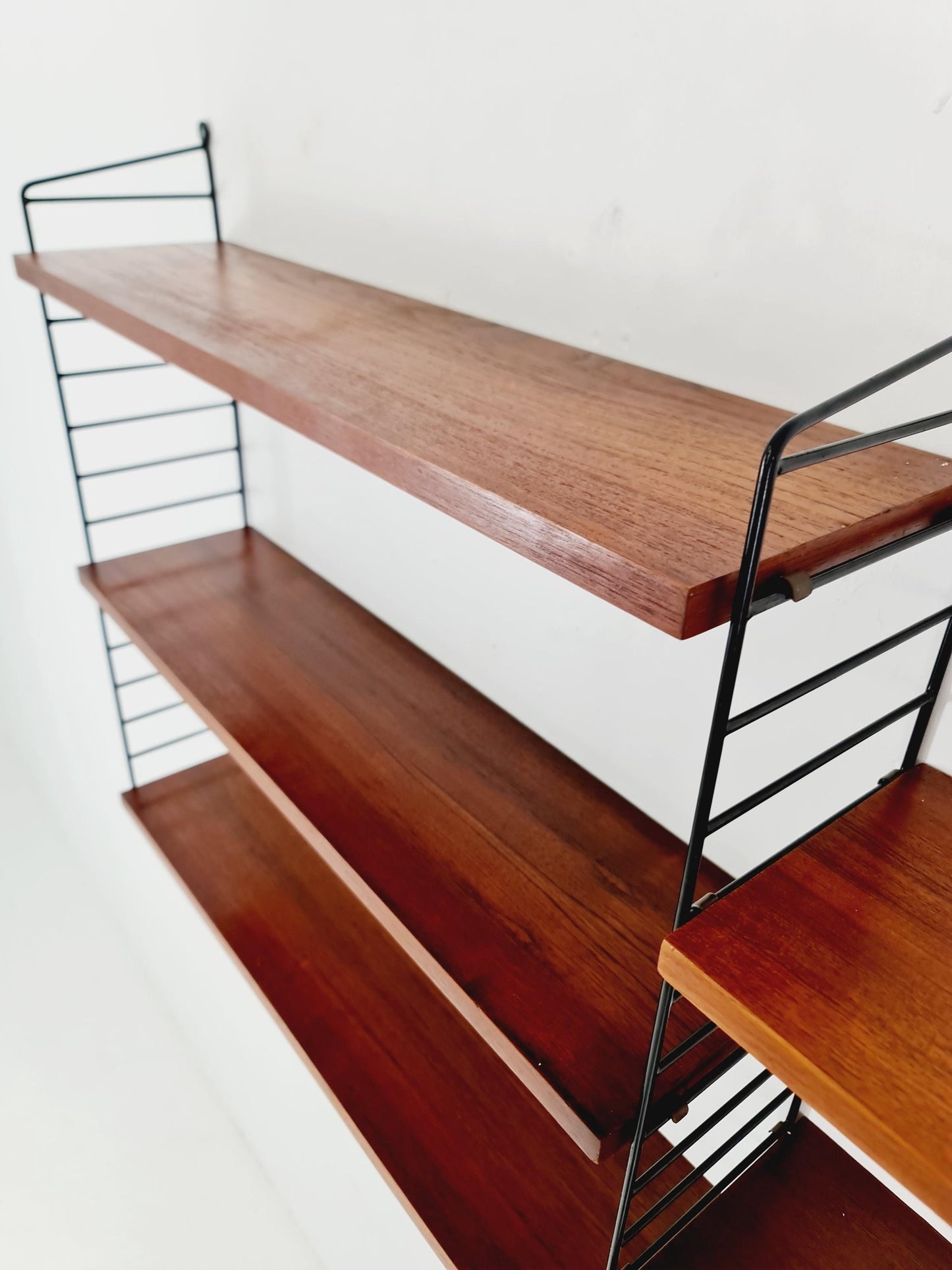 Original MCM Teak shelving system - consists of black lacquered metal ladders, from string Stockholm 1960s