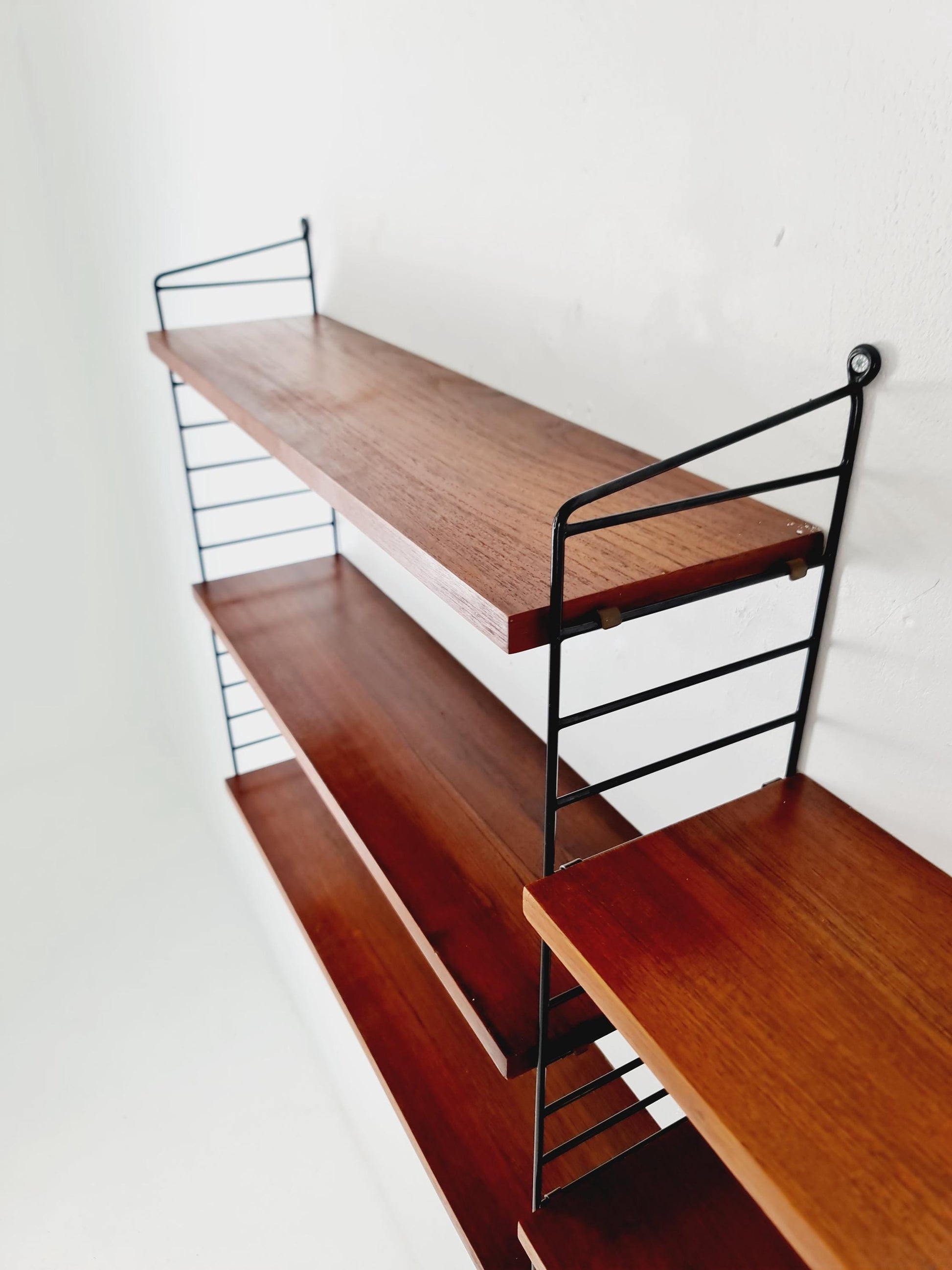 Original MCM Teak shelving system - consists of black lacquered metal ladders, from string Stockholm 1960s