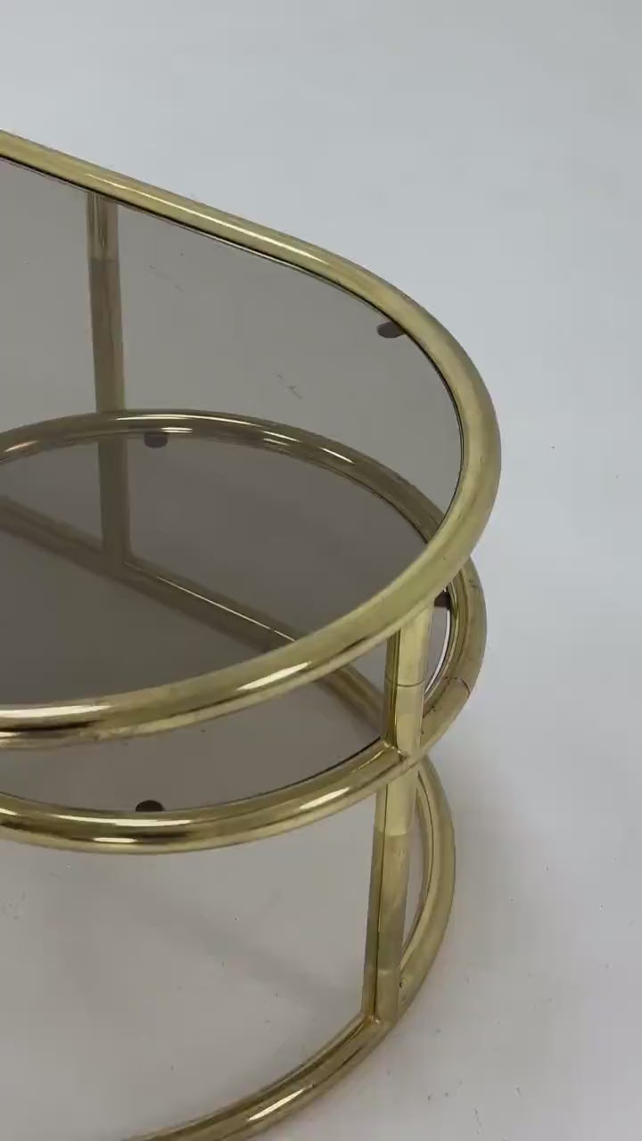 Mid century swivel coffee table brass & smoked glass ,by Milo Baughman, 1970s Italy